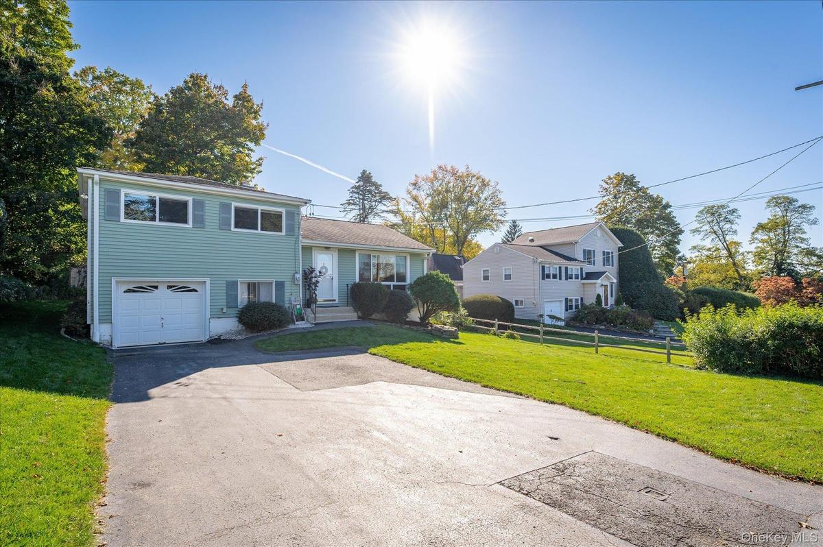 Driveway with room for 3 cars leads to attached 1 car garage.
