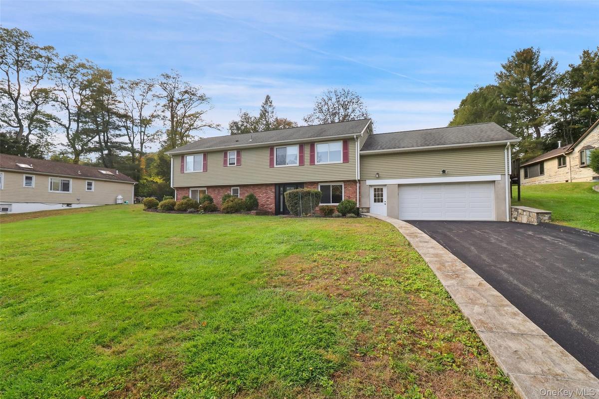 With attached two car garage plus one extra bay