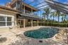 Lagoon inspired pool complete with beach area and rock water feature.