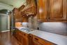 The six-burner gas cooktop, built-in ovens, built-in GE Monogram refrigerator are just icing on the cake.