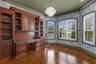 But there is still space for a desk, worktable, and a full wall of windows overlooking the front of the property.