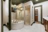 The deep jetted tub and fully tiled walk-in shower.
