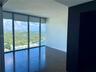 Floor-to-ceiling windows, large-format tile flooring, and a contrast wall featuring a dark finish