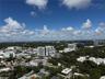 Aerial perspective showcasing an expansive urban landscape with dense tree canopy and mid-rise architecture