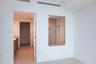 Shower enclosure with a glass partition, wall-mounted shower head, and built-in wall niche, featuring wood-finish wall tile and wood-finish flooring