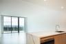 Open-concept kitchen featuring an island with stone-finish countertops, undermount stainless steel sink, and wood-finish cabinetry, complemented by fl