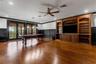 The built-in entertainment system, custom wainscoting all around and two sets of glass doors that open to the balcony.