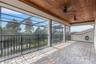 With wood ceiling above and brick pavers under foot.