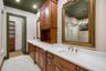 The ensuite bathroom features a long-split vanity with central tower for added storage.