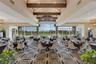 The elegant main dining room has stunning panoramic views of the golf course beyond.