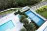 Outdoor recreation area featuring a tennis court, swimming pool, spa, and mature palm tree landscaping