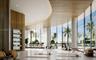 Floor-to-ceiling curved glass walls, expansive wood-paneled ceiling, recessed lighting, built-in shelving, and stone-finish flooring