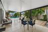 Covered patio with neutral tile flooring, wood decking, and a swimming pool