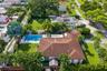 Aerial perspective featuring a shingled roofline, in-ground swimming pool, manicured lawn, and mature perimeter landscaping