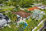 Aerial perspective featuring a shingle-roof residence, an in-ground swimming pool, a concrete patio, established palm trees, and a fenced perimeter