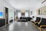 Large-format tile flooring, oversized bay window, and contemporary spherical chandelier