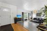 Entrance featuring a semi-circular transom window, large-format tile flooring, wood-finish entryway flooring, and a spherical tiered chandelier
