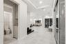 Interior space featuring large-format tile flooring, recessed ceiling lighting, tray ceilings, built-in cabinetry, and sliding glass doors