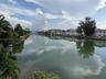 Waterfront canal exposure with mature tropical landscaping and shoreline palms