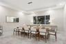 Tray ceiling with recessed lighting, linear pendant fixture, large-format tile flooring, and built-in cabinetry featuring a smooth countertop