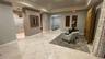 Lobby area featuring large-format tile flooring, a recessed tray ceiling, and built-in metal postal boxes