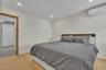 Wood-finish flooring, recessed lighting, and wall-mounted climate control unit