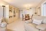Interior space featuring diagonal tile flooring, custom built-in cabinetry with glass-front display sections, and a multi-arm chandelier