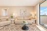 Floor-to-ceiling sliding glass door, light-toned tile flooring, and neutral wall textures