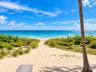 Private beach access featuring a sand path, native coastal landscaping, and direct oceanfront exposure