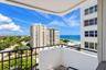 Private balcony with black metal railing overlooking the oceanfront and coastal landscape