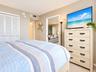 Room interior featuring neutral wall paint, wall-to-wall carpeting, and double-door bi-fold closet