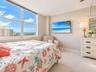 Large-format windows featuring expansive exterior scenery, neutral wall tones, and wall-to-wall carpeting
