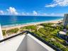 Balcony featuring a black metal railing and expansive coastal scenery