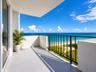 Private balcony featuring a solid surface floor, black metal railing, and direct water frontage