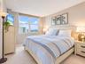 Neutral-toned room featuring a large dual-pane window, wall-to-wall carpeting, and light-toned interior paint