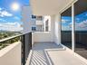 Private balcony featuring a concrete surface, black metal railing, and sliding glass door access