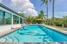 Rectangular pool with tiled steps, surrounded by a paved deck