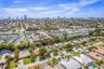 Aerial perspective featuring a canal, residential structures, and commercial properties