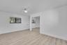 Light wood-finish flooring with white walls