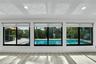 Light wood-finish flooring, recessed ceiling lighting, roller shades, and a swimming pool