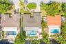 Property featuring a tiled roof, private swimming pool, and mature landscaping