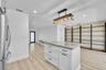 Kitchen island with a light-colored countertop and white cabinetry