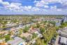 Waterfront property featuring a private boat dock, mature landscaping, and an inground swimming pool