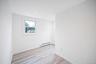 Neutral interior space featuring vinyl wood-finish flooring, recessed lighting, and double-pane windows
