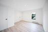Room featuring vinyl wood-finish flooring, recessed lighting, and white six-panel doors