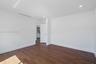 Wood-finish flooring, recessed lighting, and crisp white wall finishes