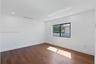 Interior space featuring wood-finish flooring, recessed lighting, and a single-pane window with a black frame