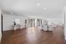 Open-concept interior featuring wood-finish flooring, recessed lighting, and multiple sliding glass door sets