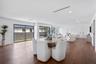 Open-concept interior featuring wood-finish flooring, recessed lighting, and multiple oversized sliding glass doors
