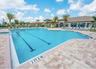 Swimming pool featuring designated lap lanes and a surrounding paved stone deck
